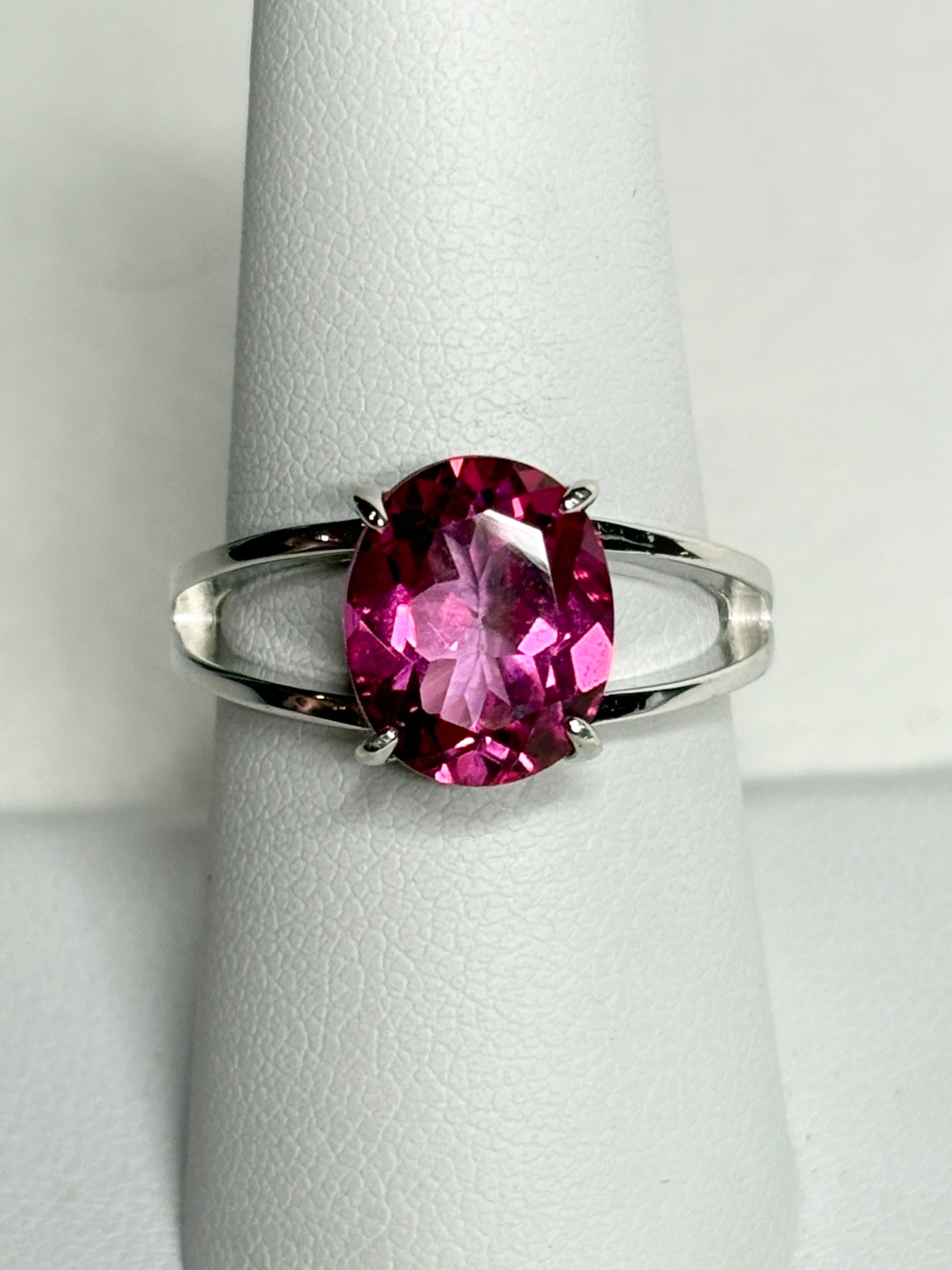 Sterling silver ring with a large oval pink topaz solitaire and split shank.