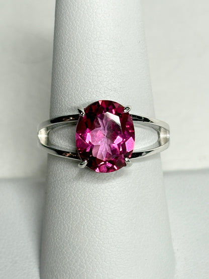 Sterling silver ring with a large oval pink topaz solitaire and split shank.