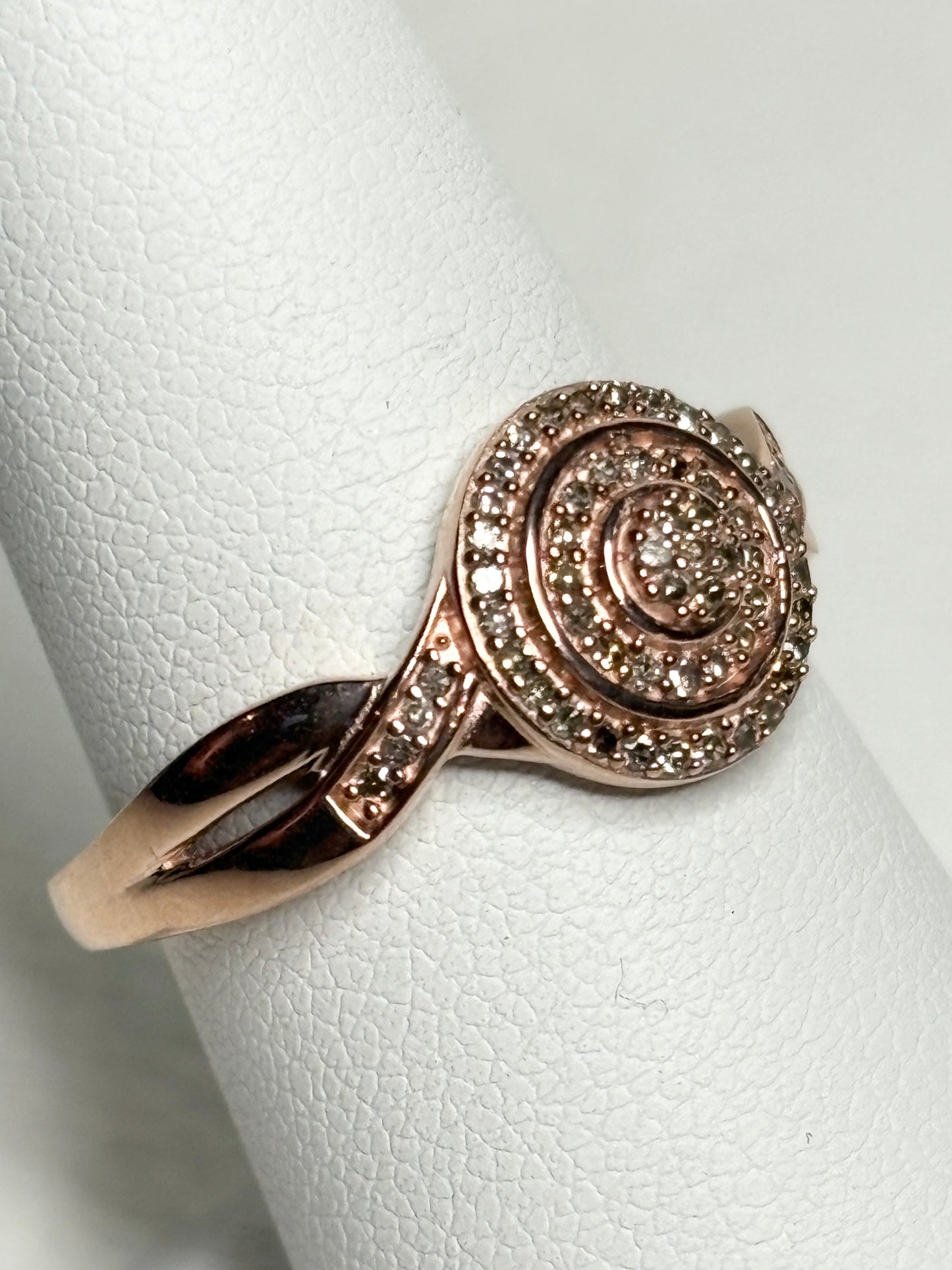 Rose gold ring with champagne and brown diamonds in a spiral design.