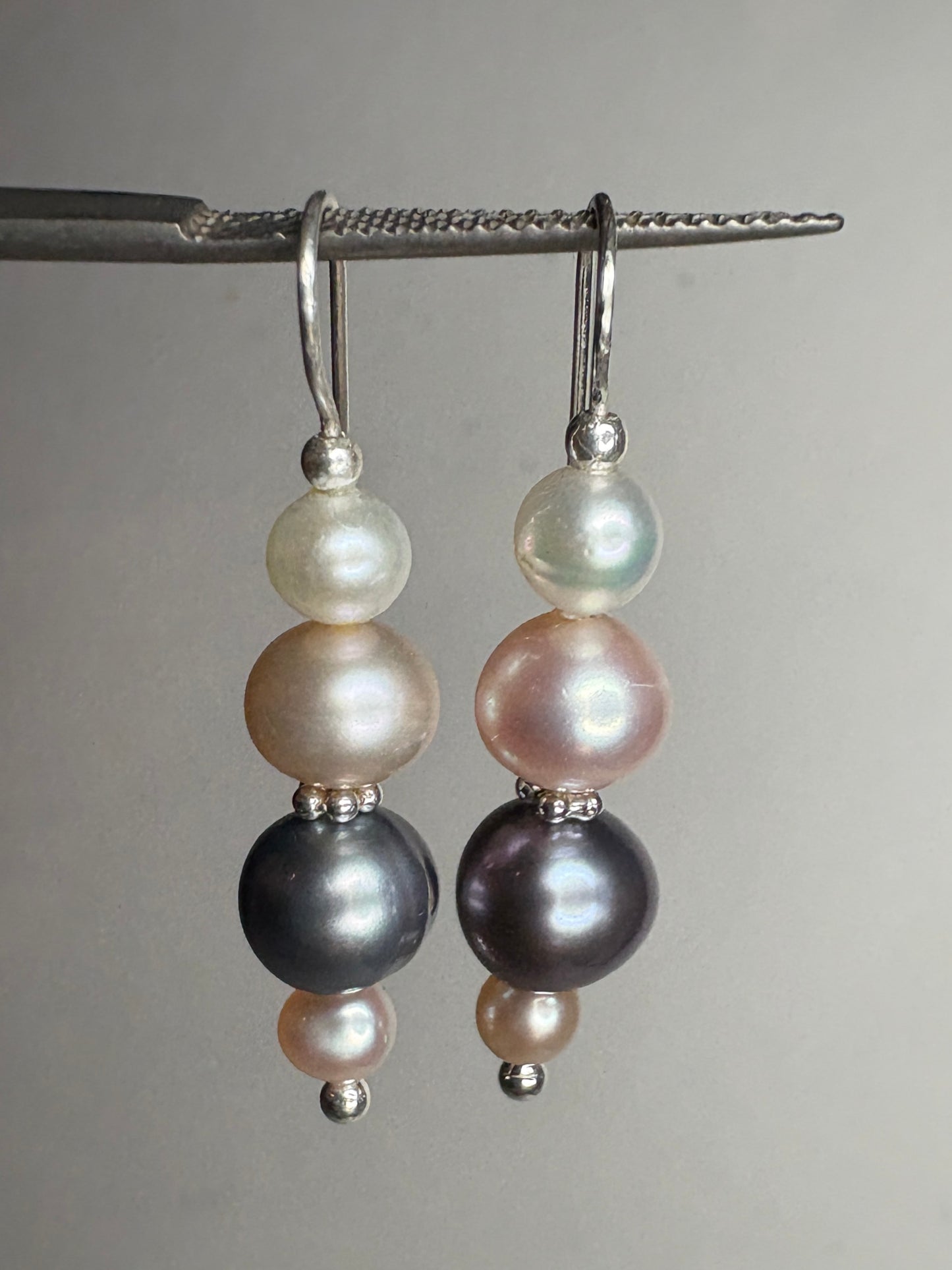 Sterling silver dangle earrings with three colorful freshwater pearls each.