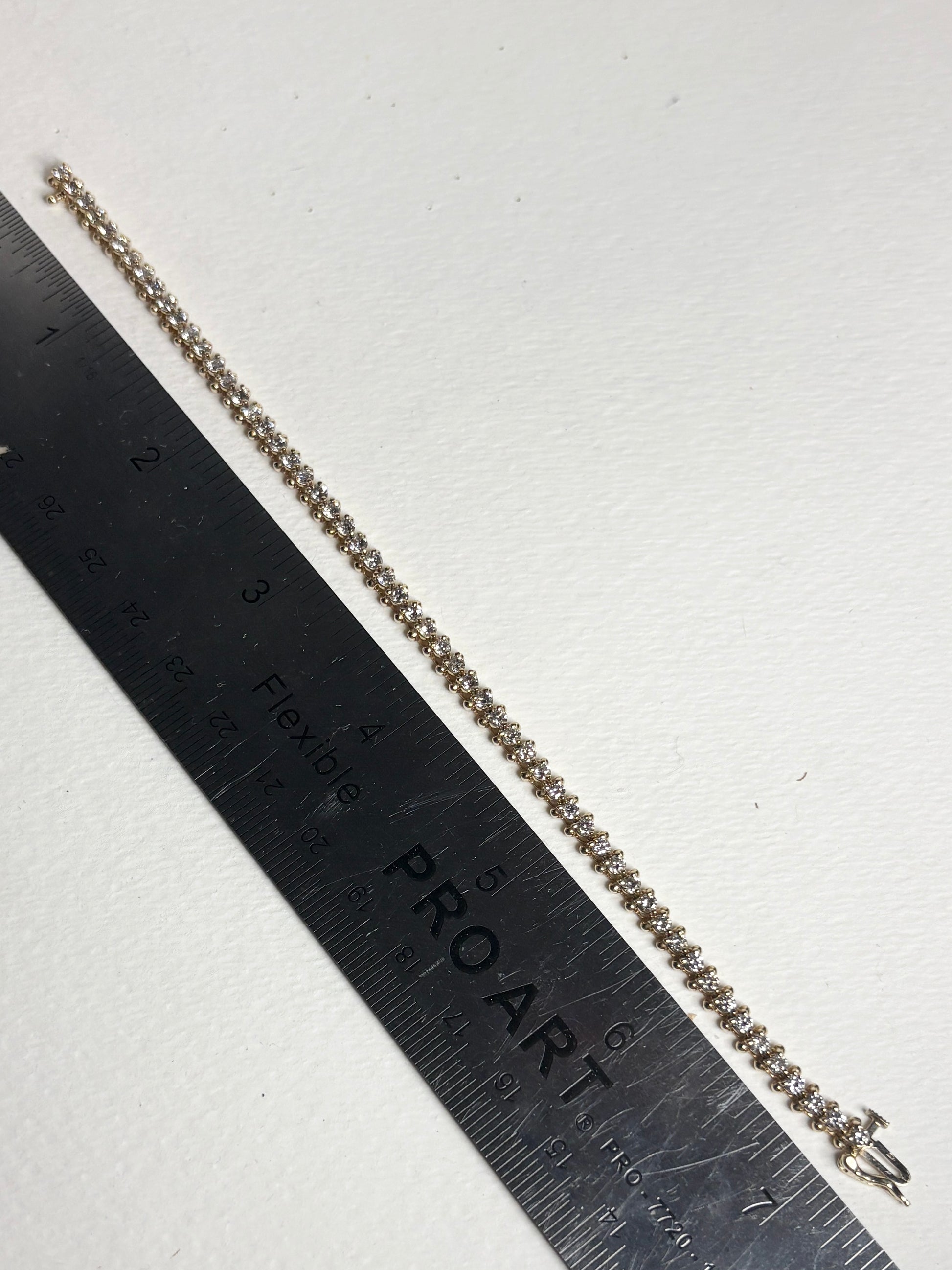 Diamond tennis bracelet with 57 stones in solid 14k gold.