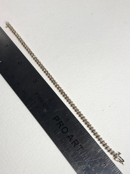 Diamond tennis bracelet with 57 stones in solid 14k gold.