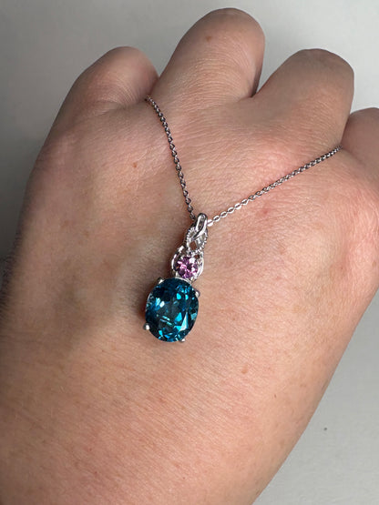 Sterling silver pendant necklace with oval London blue topaz and rhodolite garnet.
