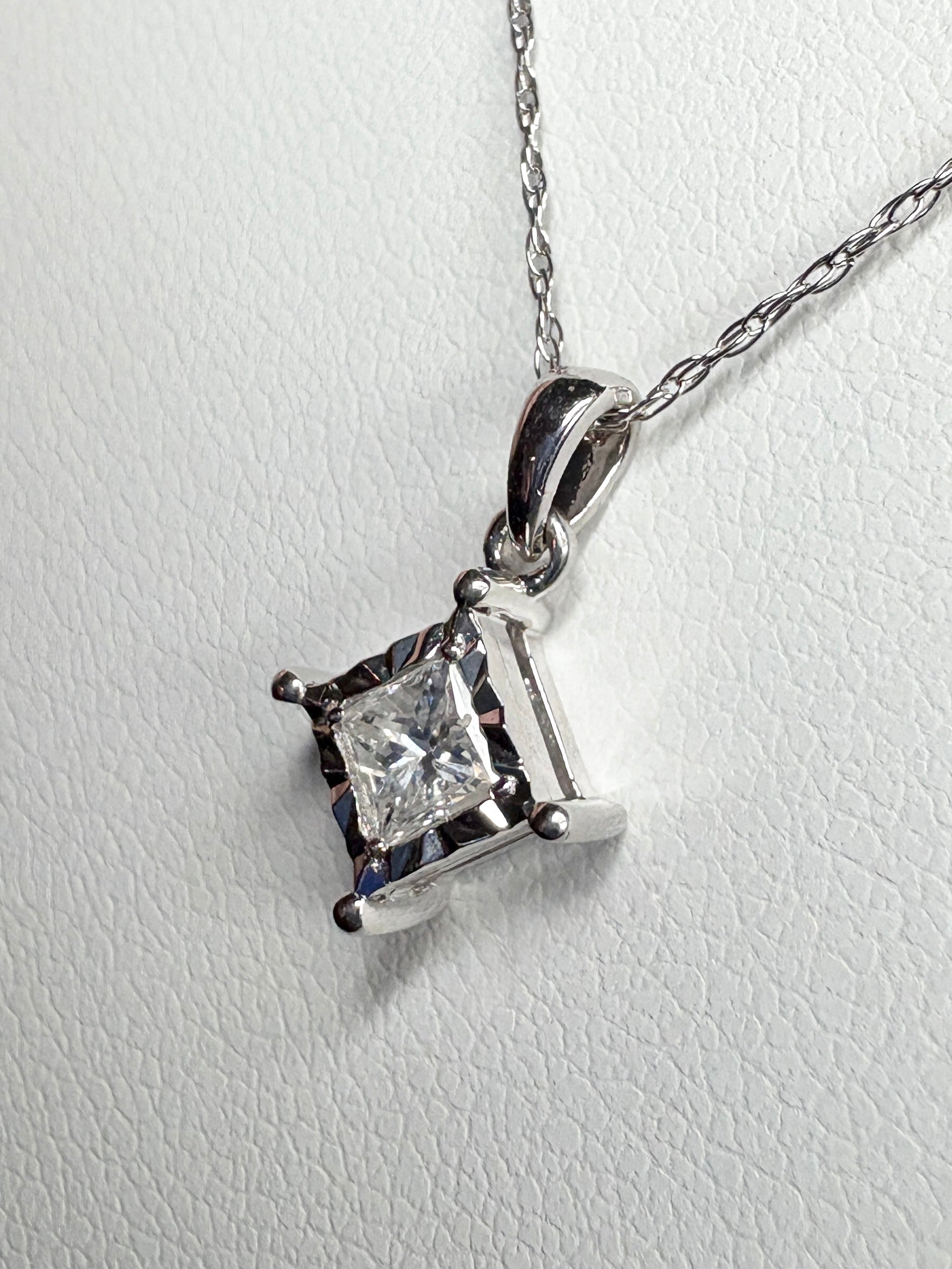 Princess cut diamond pendant necklace in 10k white gold.