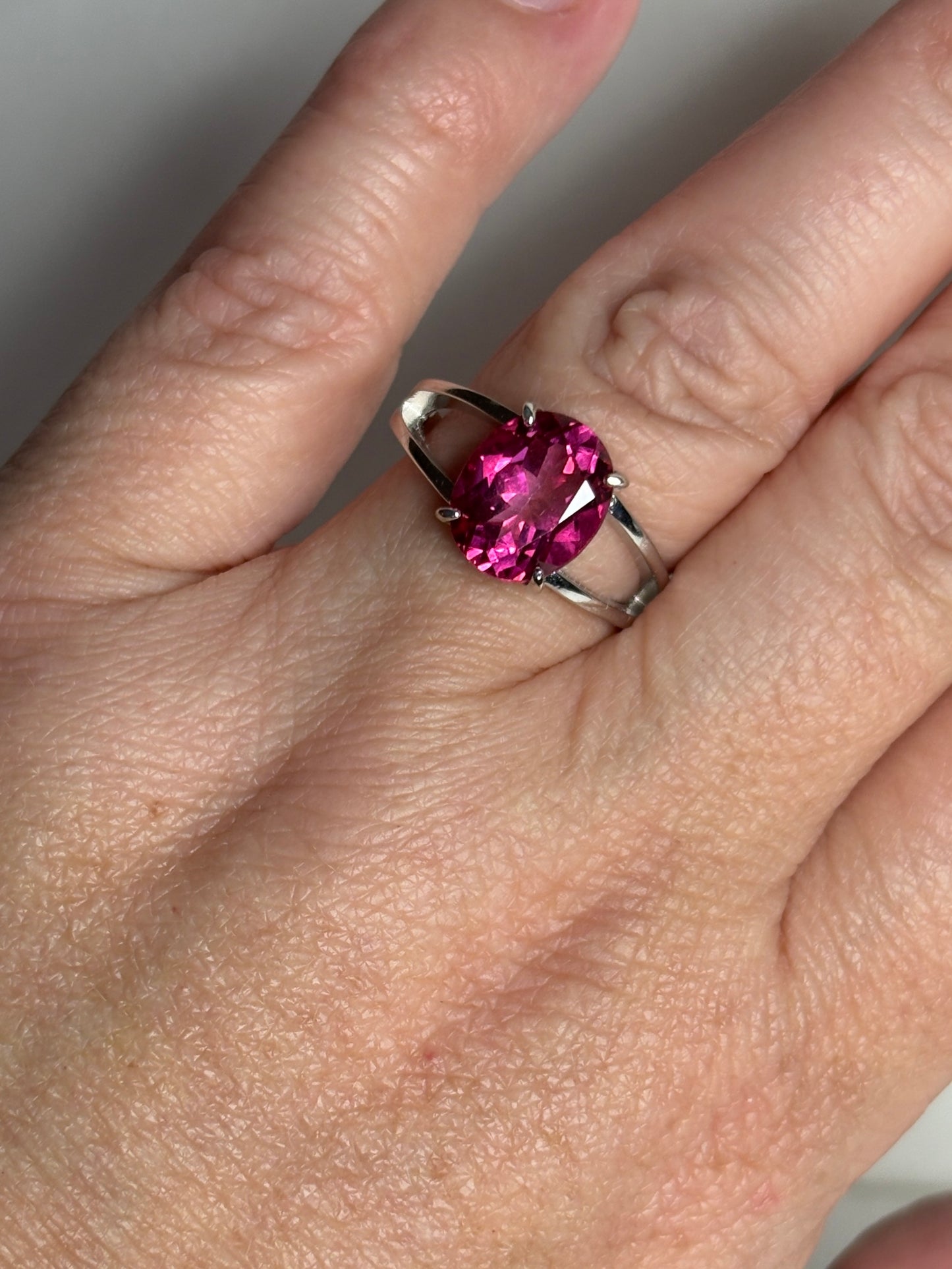 Sterling silver ring with a large oval pink topaz solitaire.