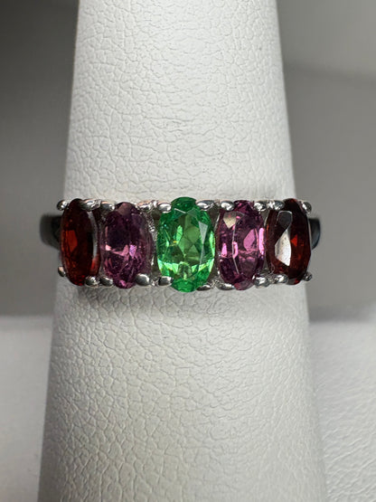 Sterling silver ring with five oval garnets in red, pink, and green.