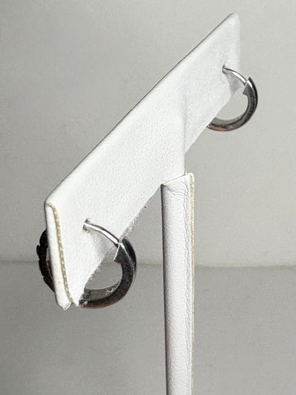 Small sterling silver huggie hoop earrings with rhodolite garnets.