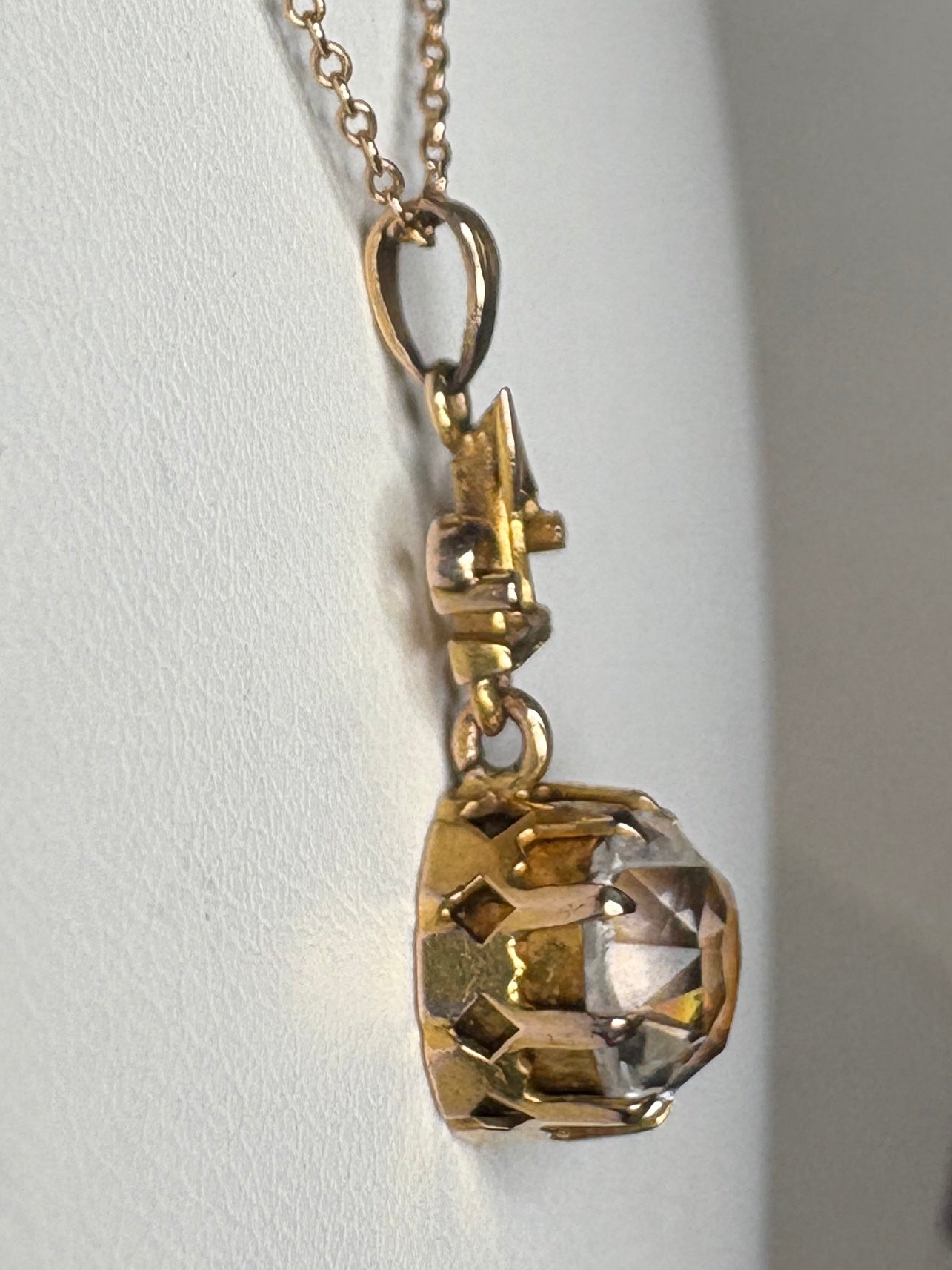 Antique Victorian Etruscan Revival rock crystal quartz pendant on a 10k gold chain.
