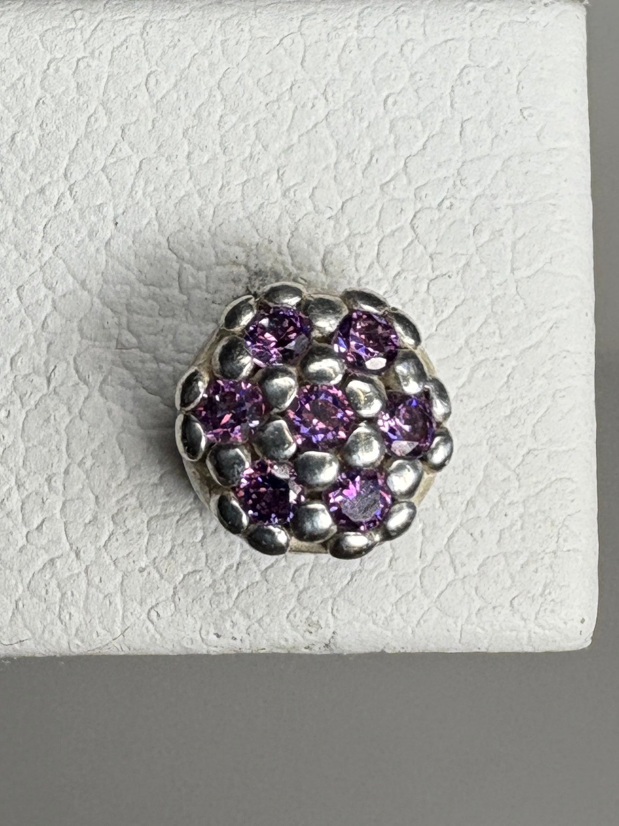 Sterling silver stud earrings with a cluster of violet purple cubic zirconia stones.