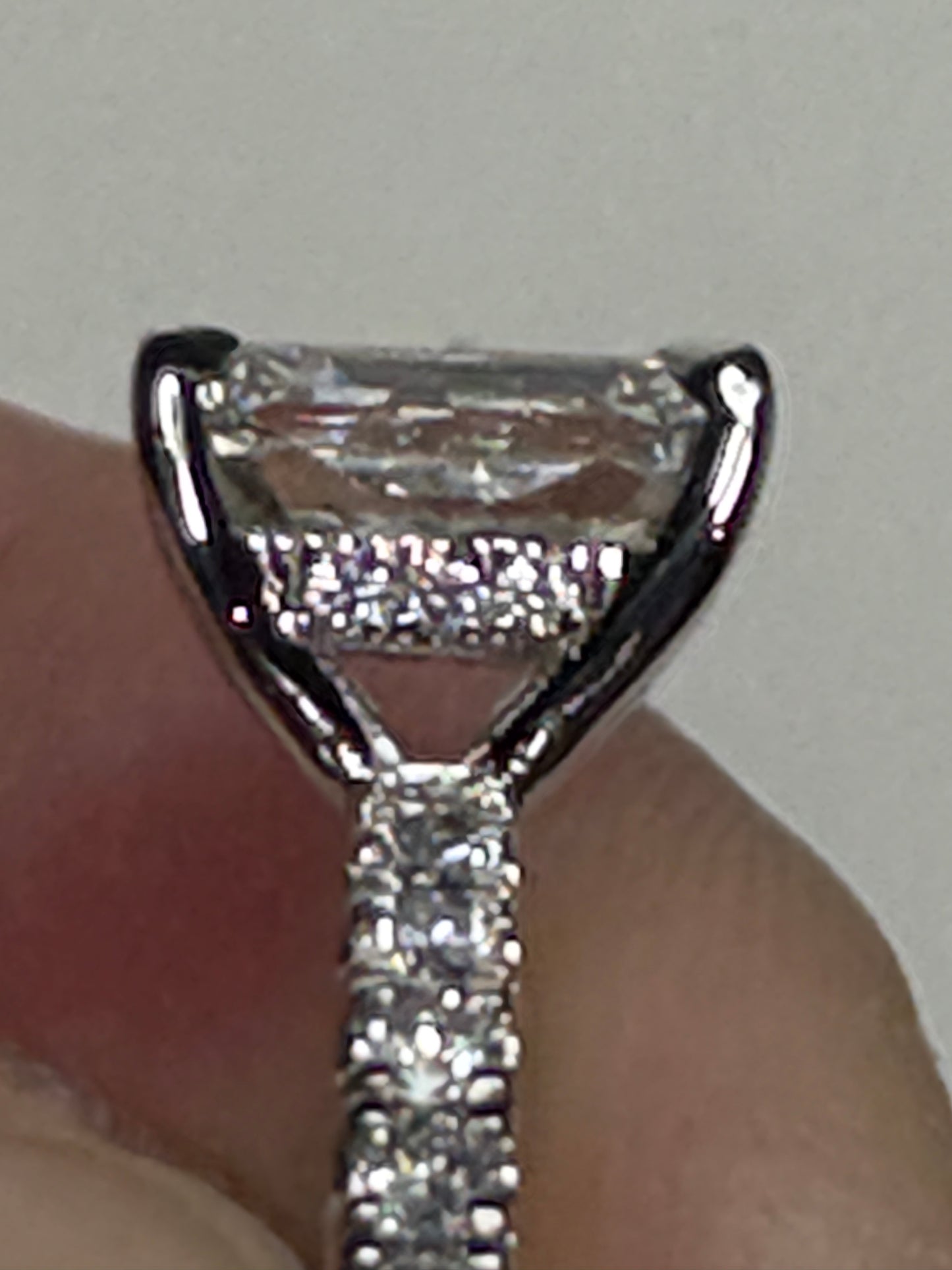 A 14k white gold engagement ring with a large center diamond and smaller accent diamonds.