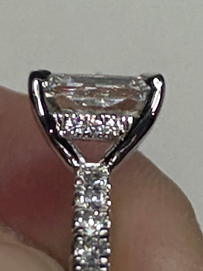 A 14k white gold engagement ring with a large center diamond and smaller accent diamonds.