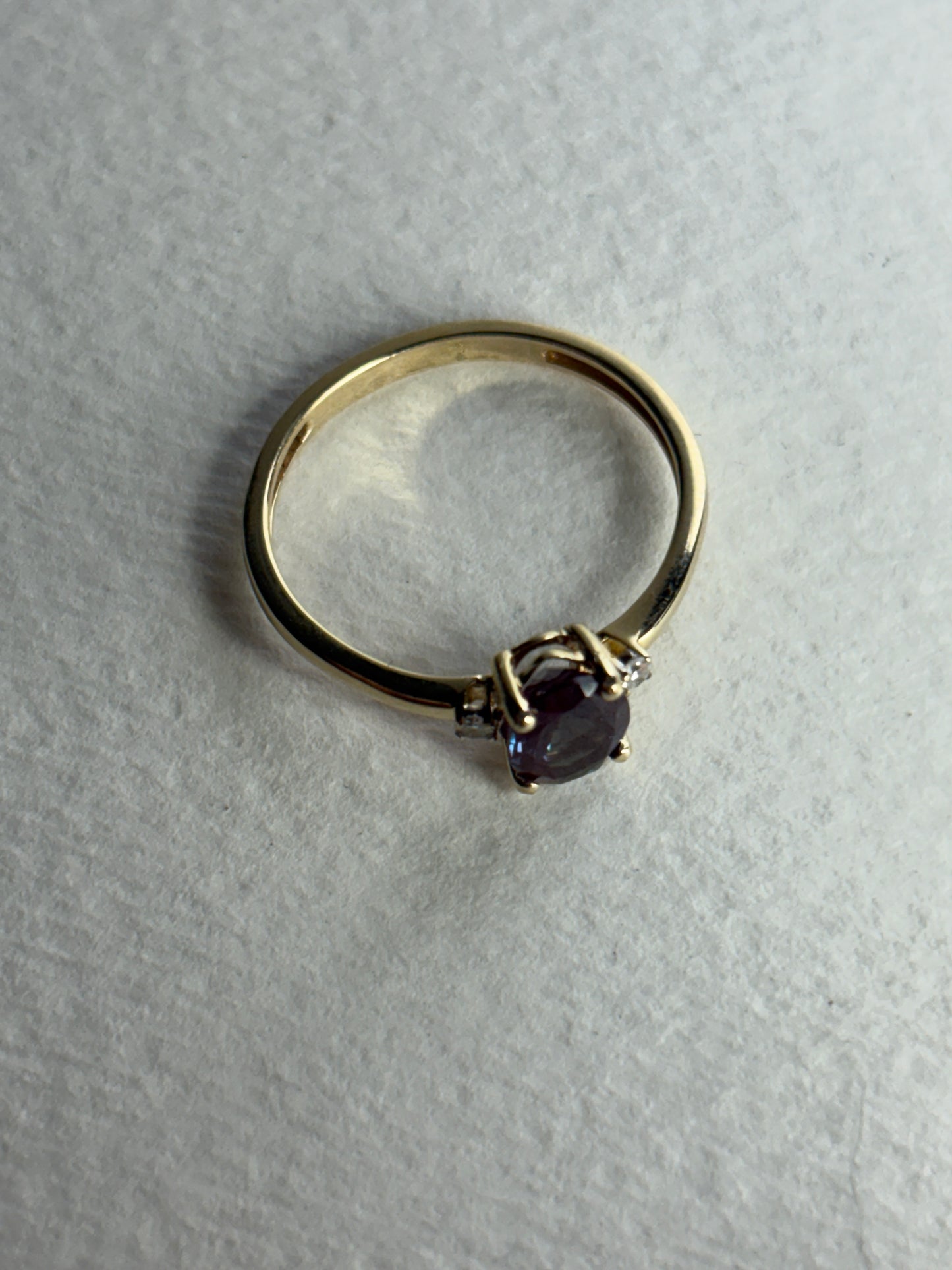 A 10k gold ring with a lab-grown alexandrite and diamonds.