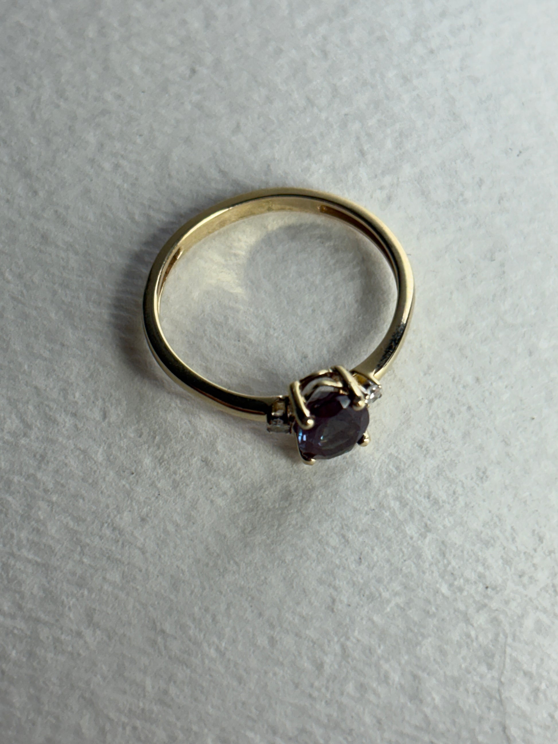 A 10k gold ring with a lab-grown alexandrite and diamonds.