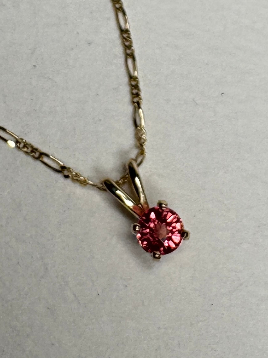 Small padparadcha sapphire solitaire pendant necklace in solid 14k gold.