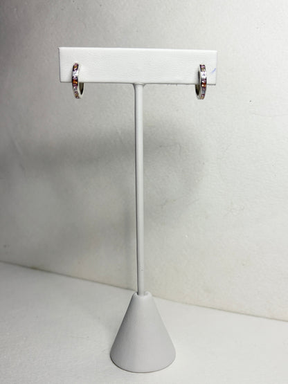 Sterling silver huggie hoop earrings with princess-cut multi-color sapphires.