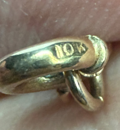 Close-up of a gold chain link with a 10k stamp.