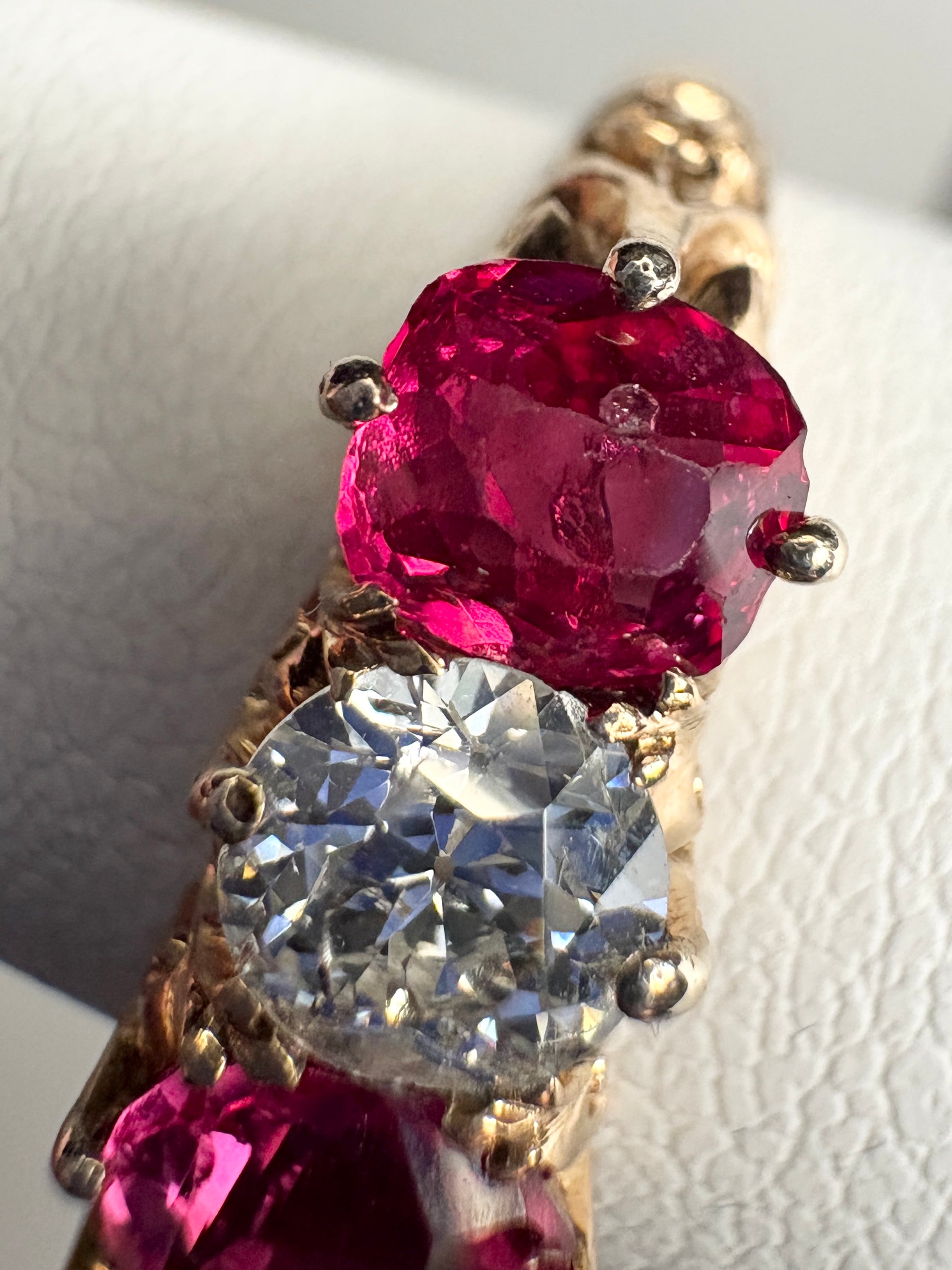Antique 14k gold ring with red spinel and old mine cut diamond on carved band.