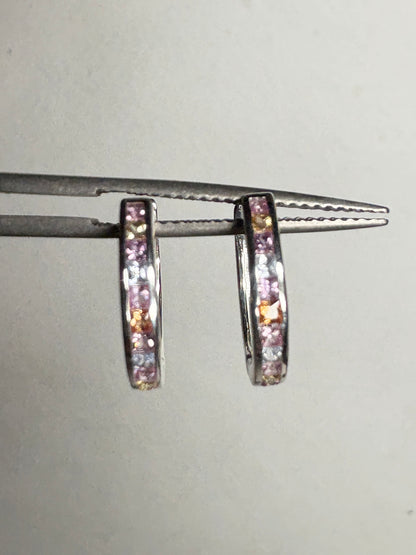 Sterling silver huggie hoop earrings with princess-cut multi-color sapphires.