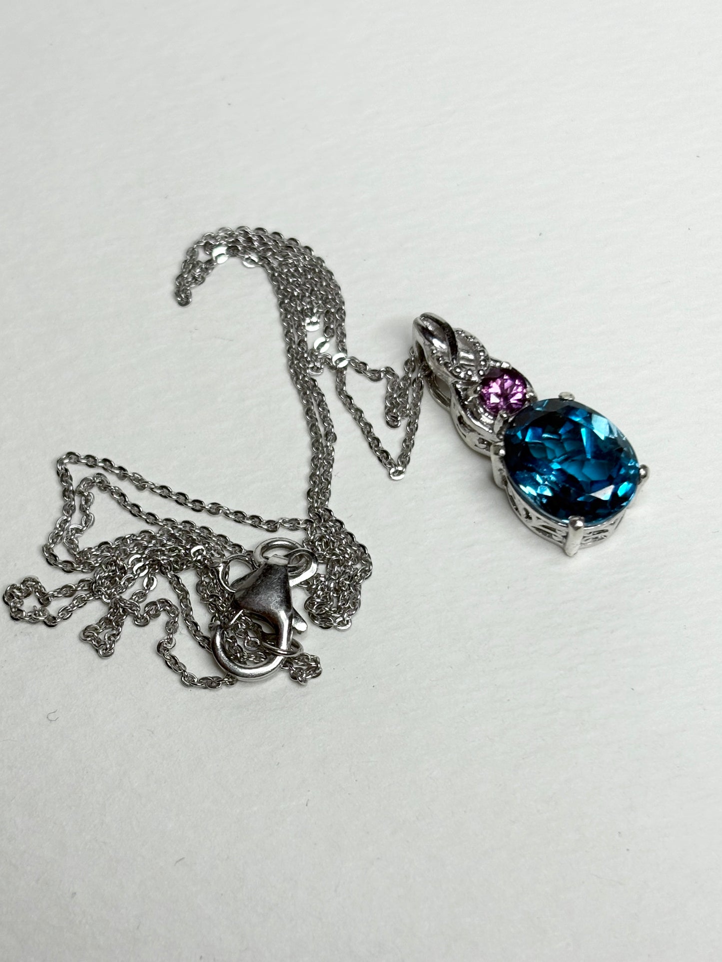 Sterling silver pendant necklace with a London blue topaz and rhodolite garnet.
