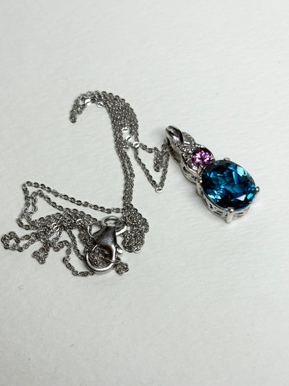 Sterling silver pendant necklace with a London blue topaz and rhodolite garnet.