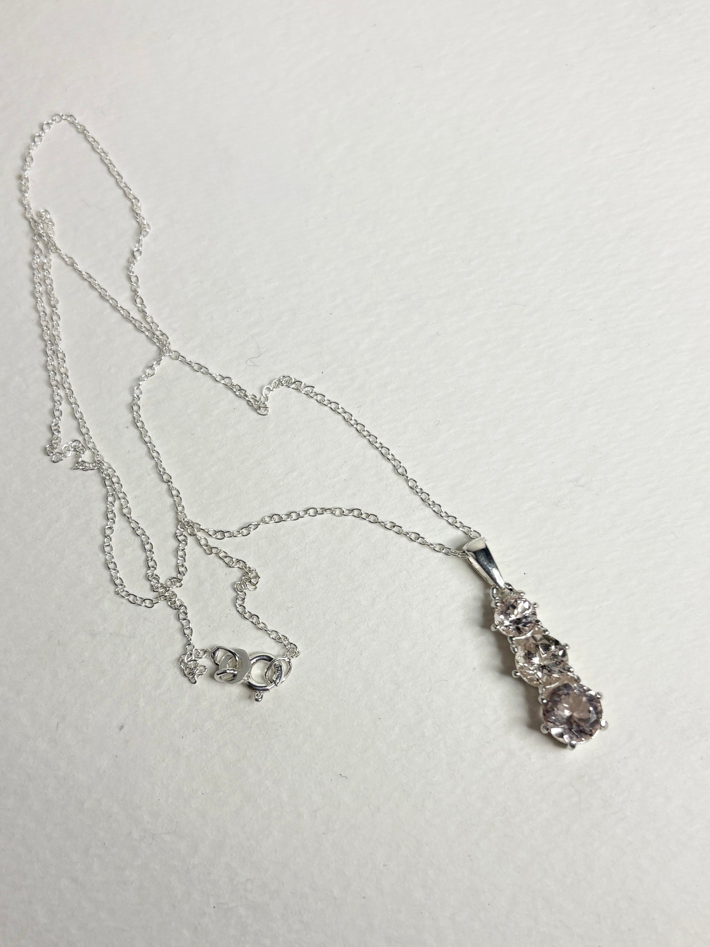 Sterling silver necklace with a pendant featuring three natural morganite stones.