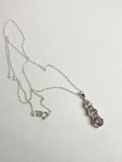Sterling silver necklace with a pendant featuring three natural morganite stones.
