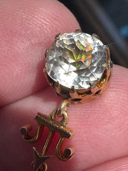 Antique Victorian Etruscan Revival rock crystal quartz pendant with a gold chain.