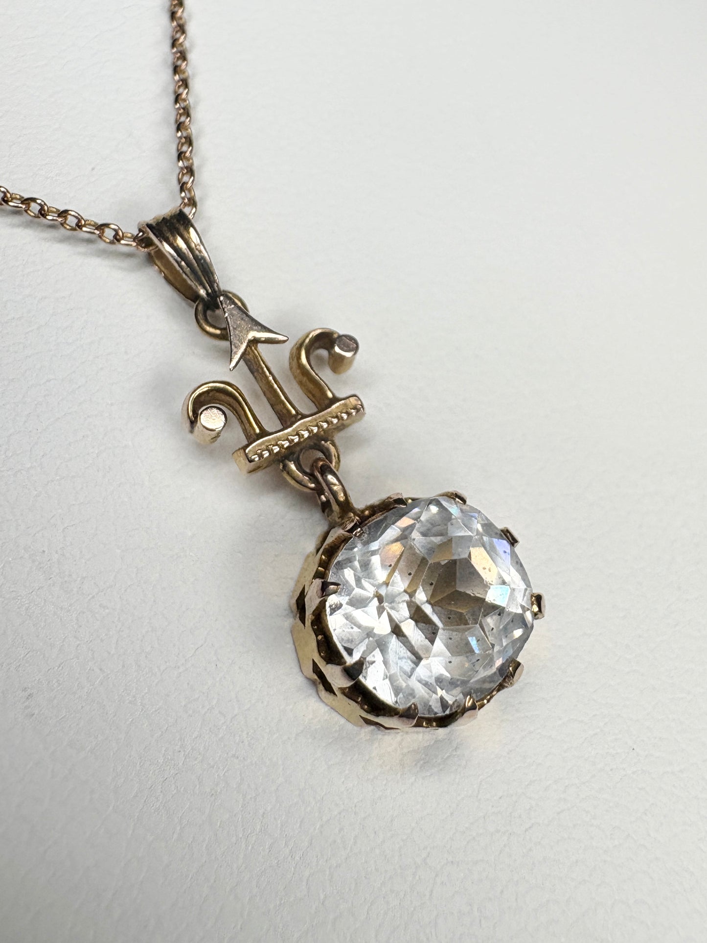 Antique Victorian Etruscan Revival rock crystal quartz pendant on a 14k gold chain.