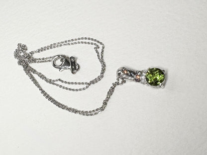 Sterling silver necklace with a green color-change glass pendant and multi-color sapphires.