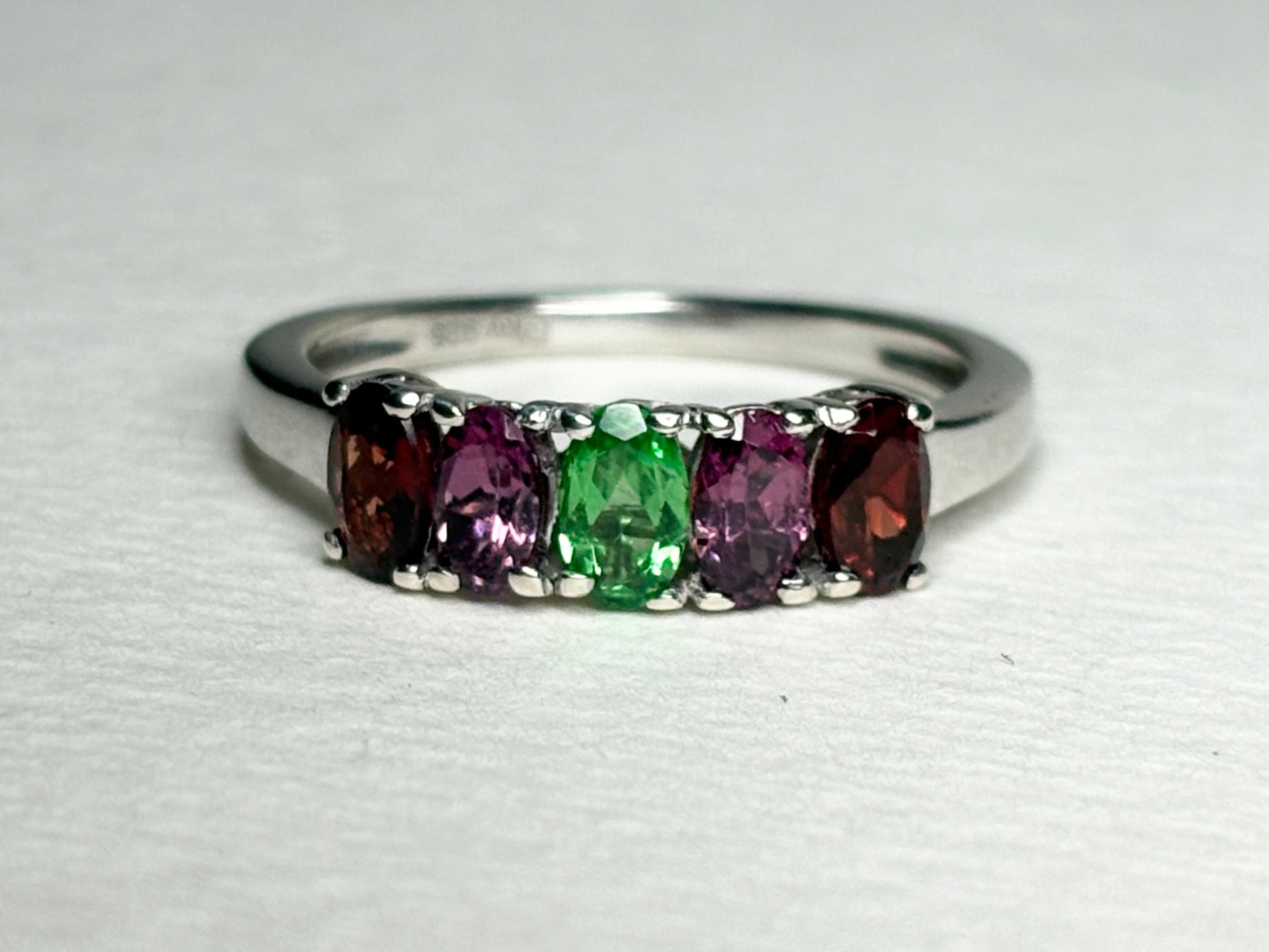 Sterling silver ring with five oval garnets: almandine, rhodolite, and tsavorite.