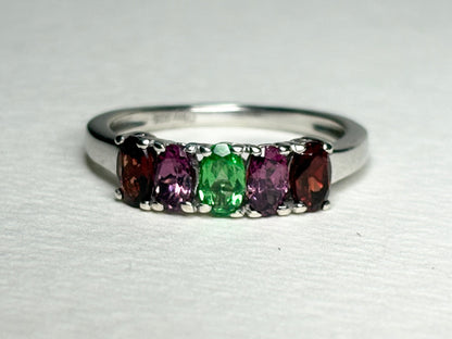 Sterling silver ring with five oval garnets: almandine, rhodolite, and tsavorite.