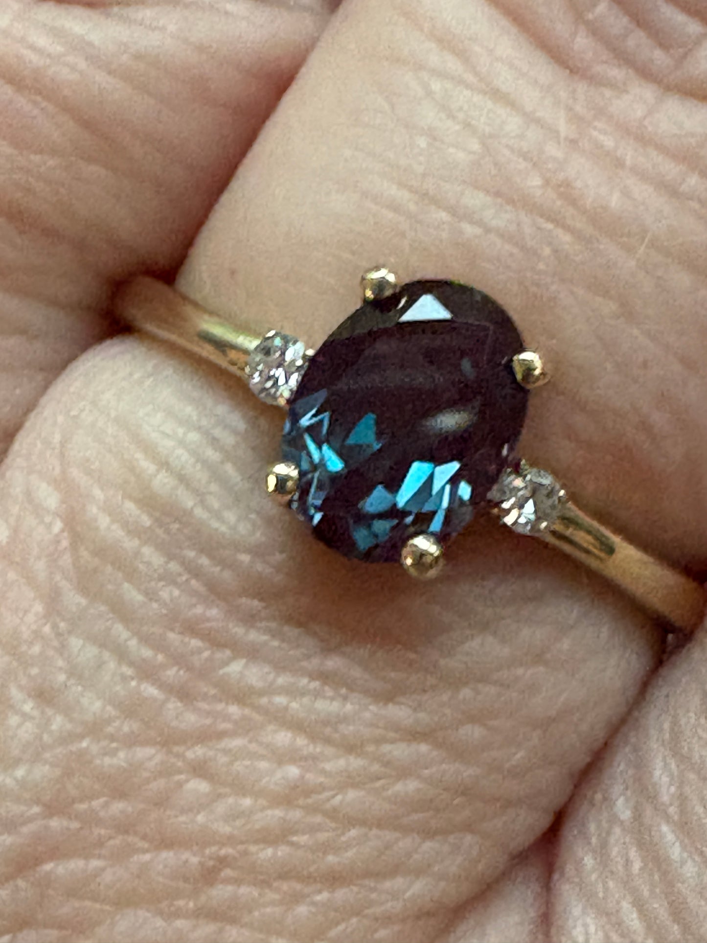 Oval lab grown alexandrite and diamond ring in 10k gold.