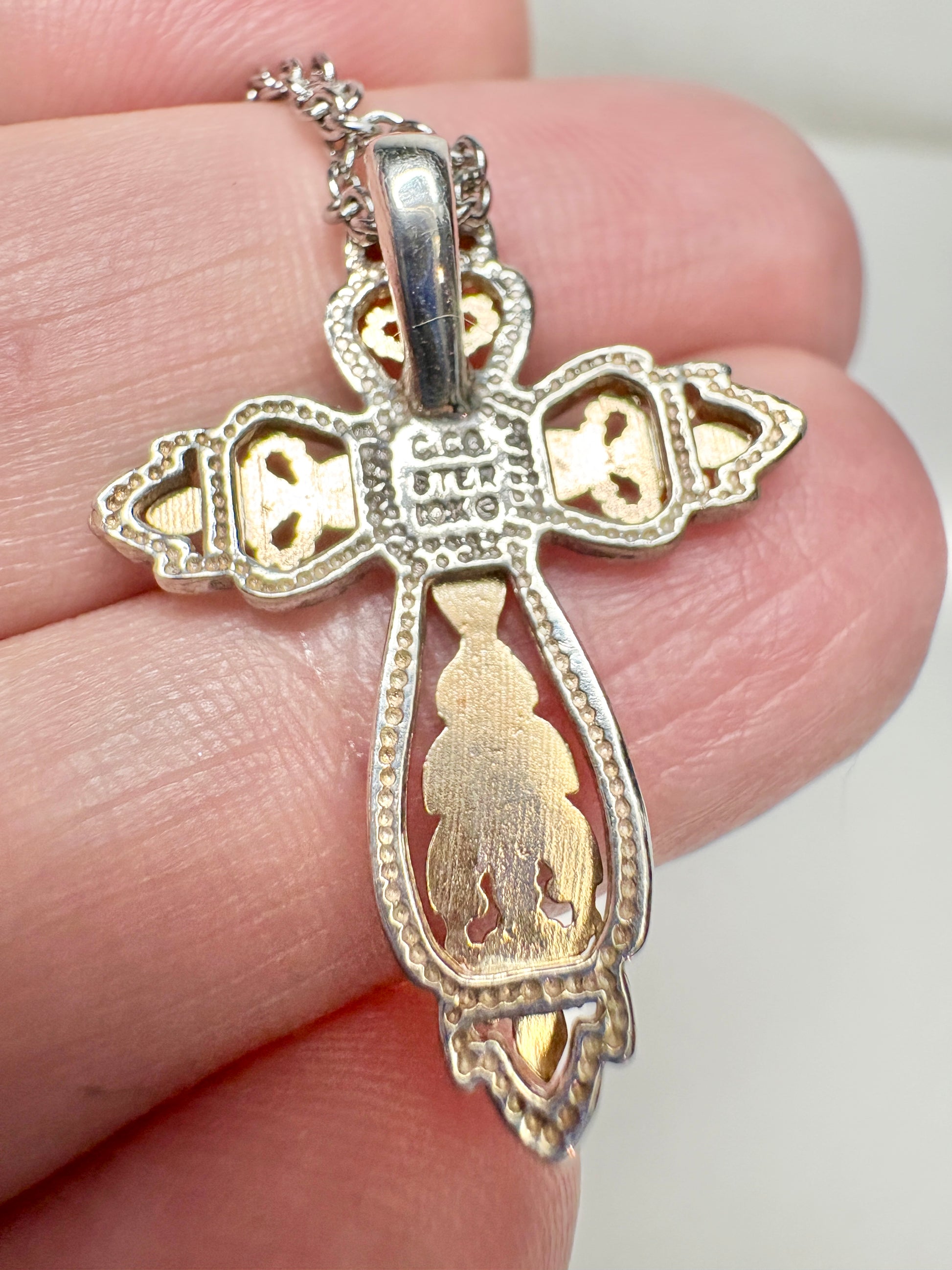 Black Hills Gold ornate cross pendant with sterling silver frame and 10k gold accents.