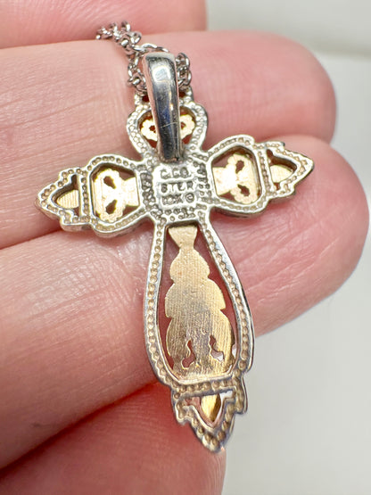 Black Hills Gold ornate cross pendant with sterling silver frame and 10k gold accents.
