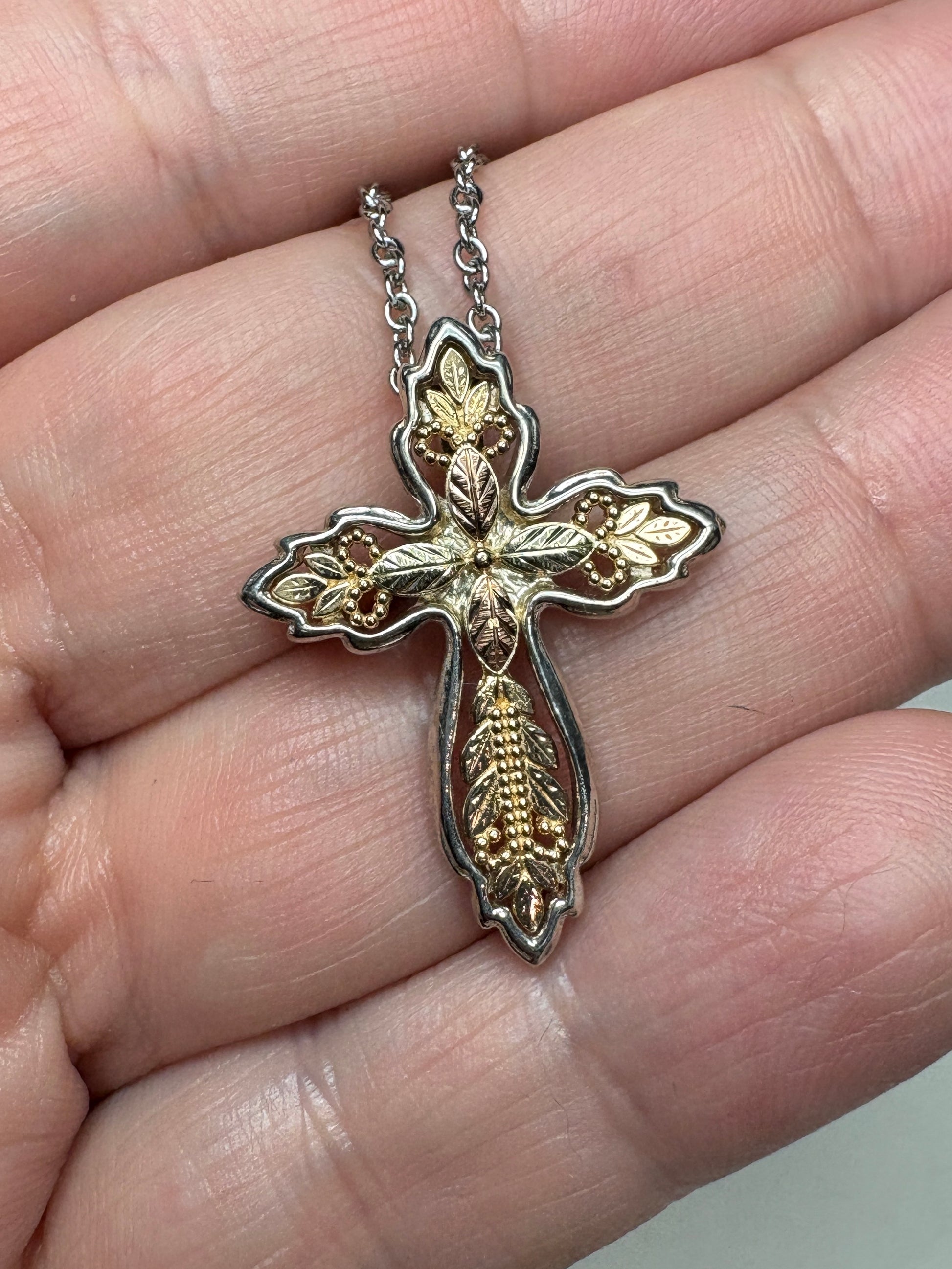 Black Hills Gold ornate cross pendant with sterling silver frame and a complimentary chain.