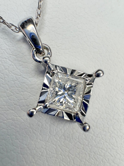 A princess cut diamond pendant necklace on a 21" white gold rope chain.