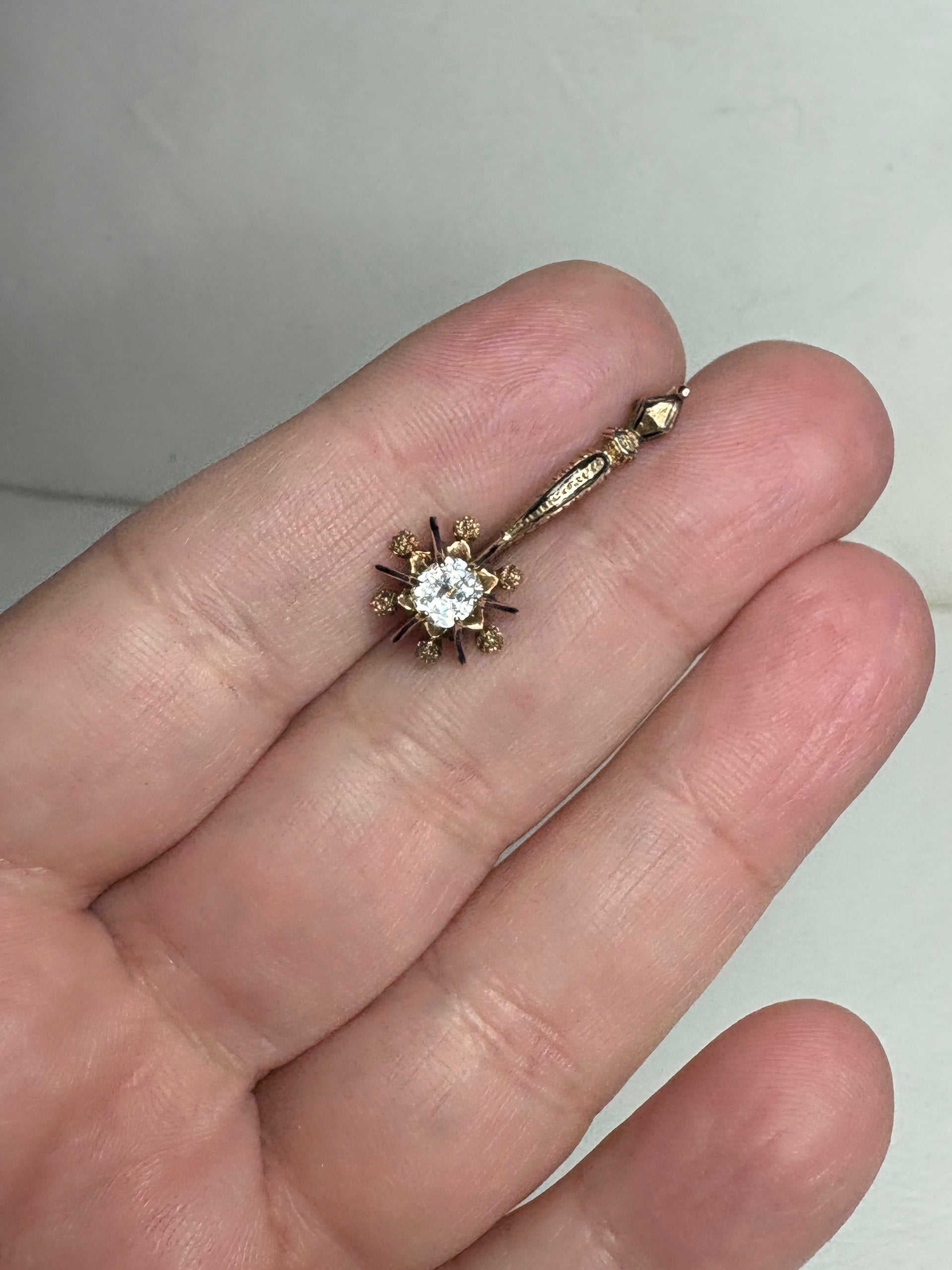 Antique 14k gold brooch with a central paste gem and enamel inlay.