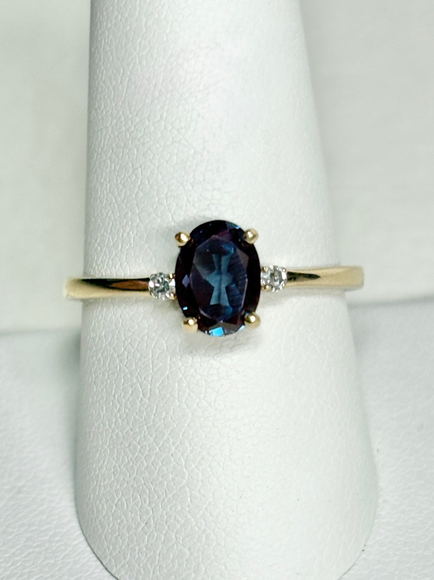 Oval lab grown alexandrite and diamond ring in 10k gold.