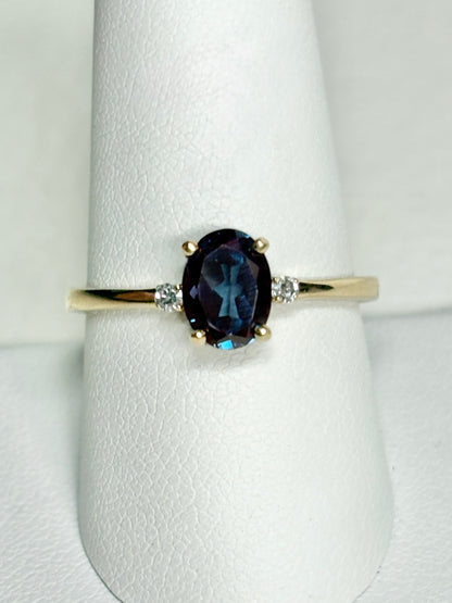 Oval lab grown alexandrite and diamond ring in 10k gold.