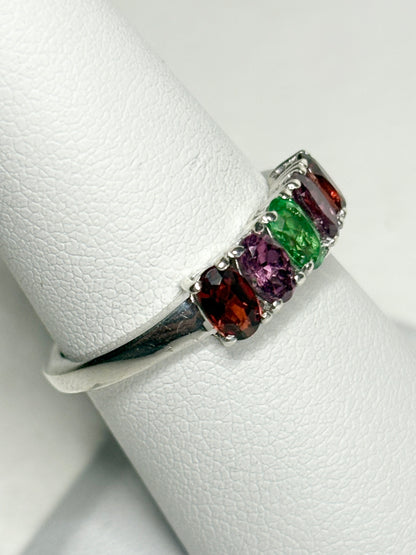 Sterling silver ring with five oval garnets in shades of red, purple, and green.