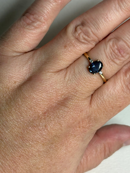 Oval lab grown alexandrite and diamond ring in 10k gold.