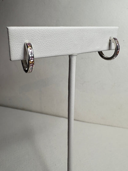 Sterling silver huggie hoop earrings with princess-cut multi-color sapphires.