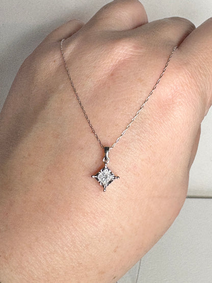 A princess cut diamond pendant on a 21-inch white gold chain.