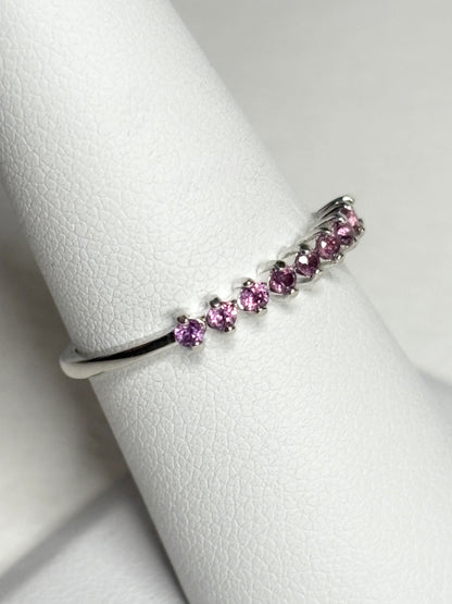 Sterling silver band ring with seven small rhodolite garnets.