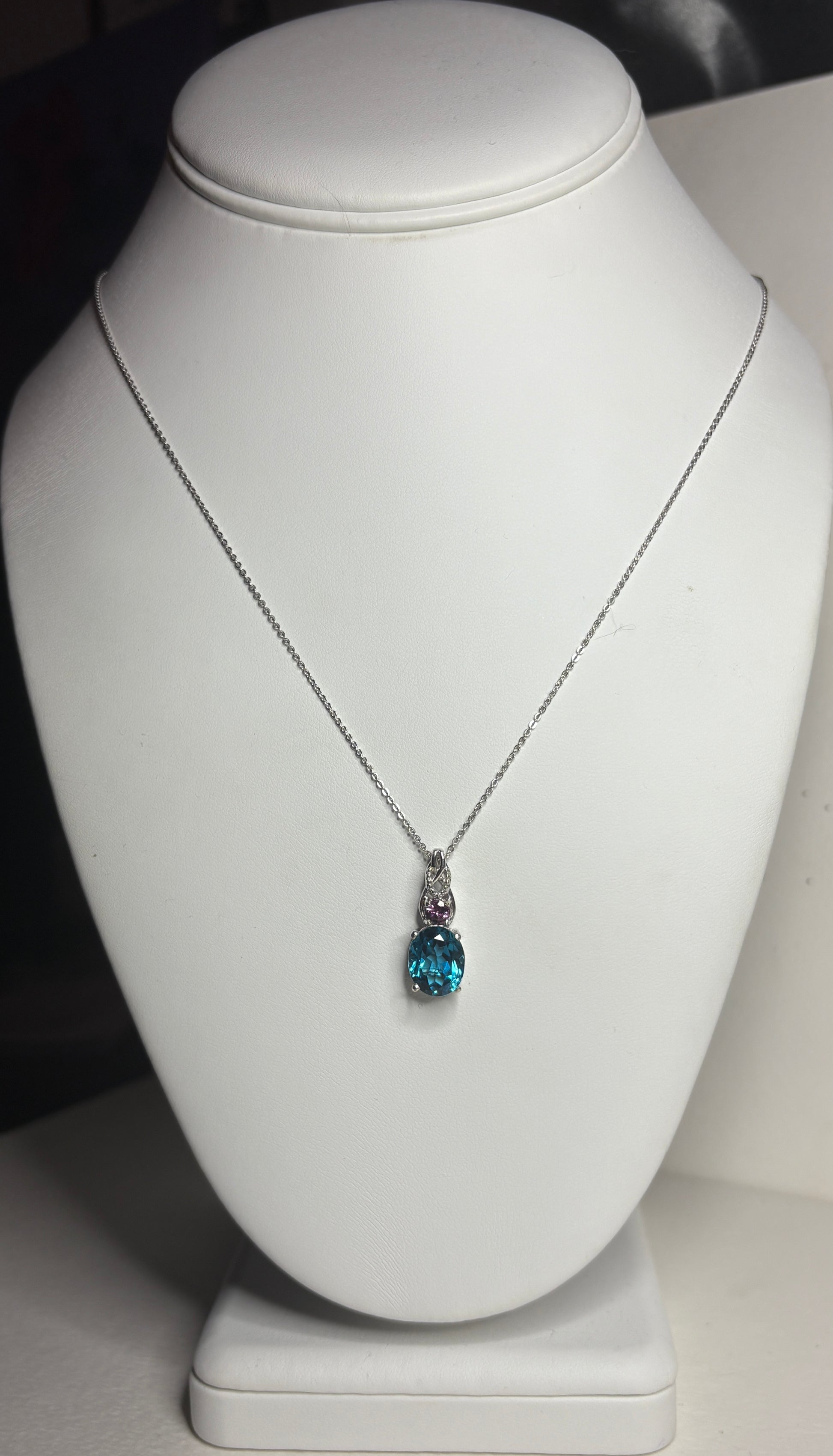 Sterling silver necklace with oval London blue topaz and rhodolite garnet pendant.