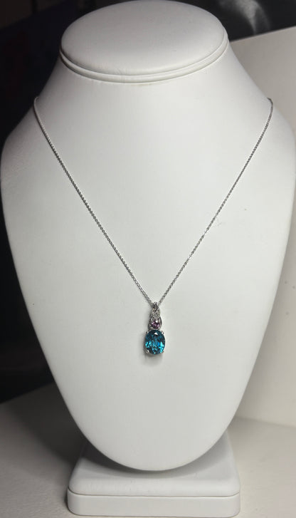 Sterling silver necklace with oval London blue topaz and rhodolite garnet pendant.