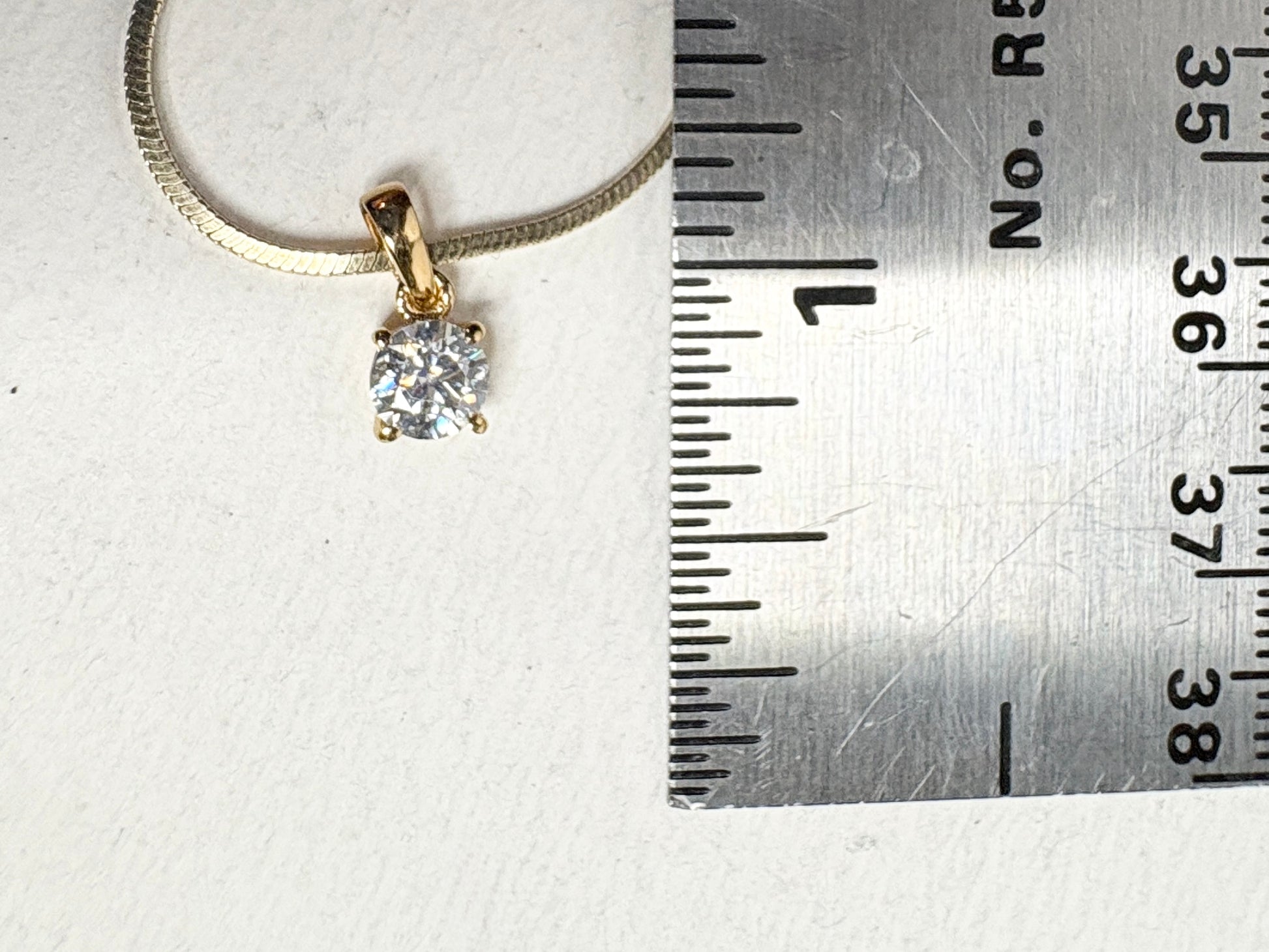 Gold over sterling silver pendant necklace with a moissanite stone.