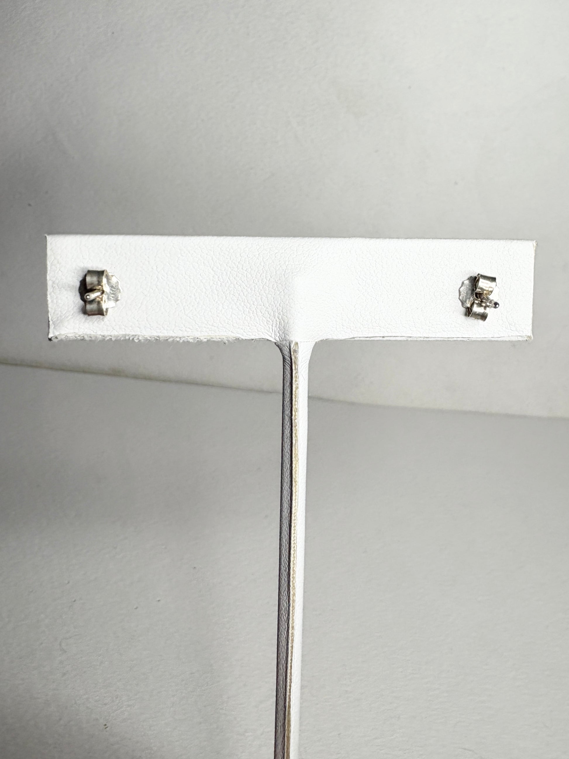 Sterling silver Pandora stud earrings with violet purple pave cubic zirconia stones.