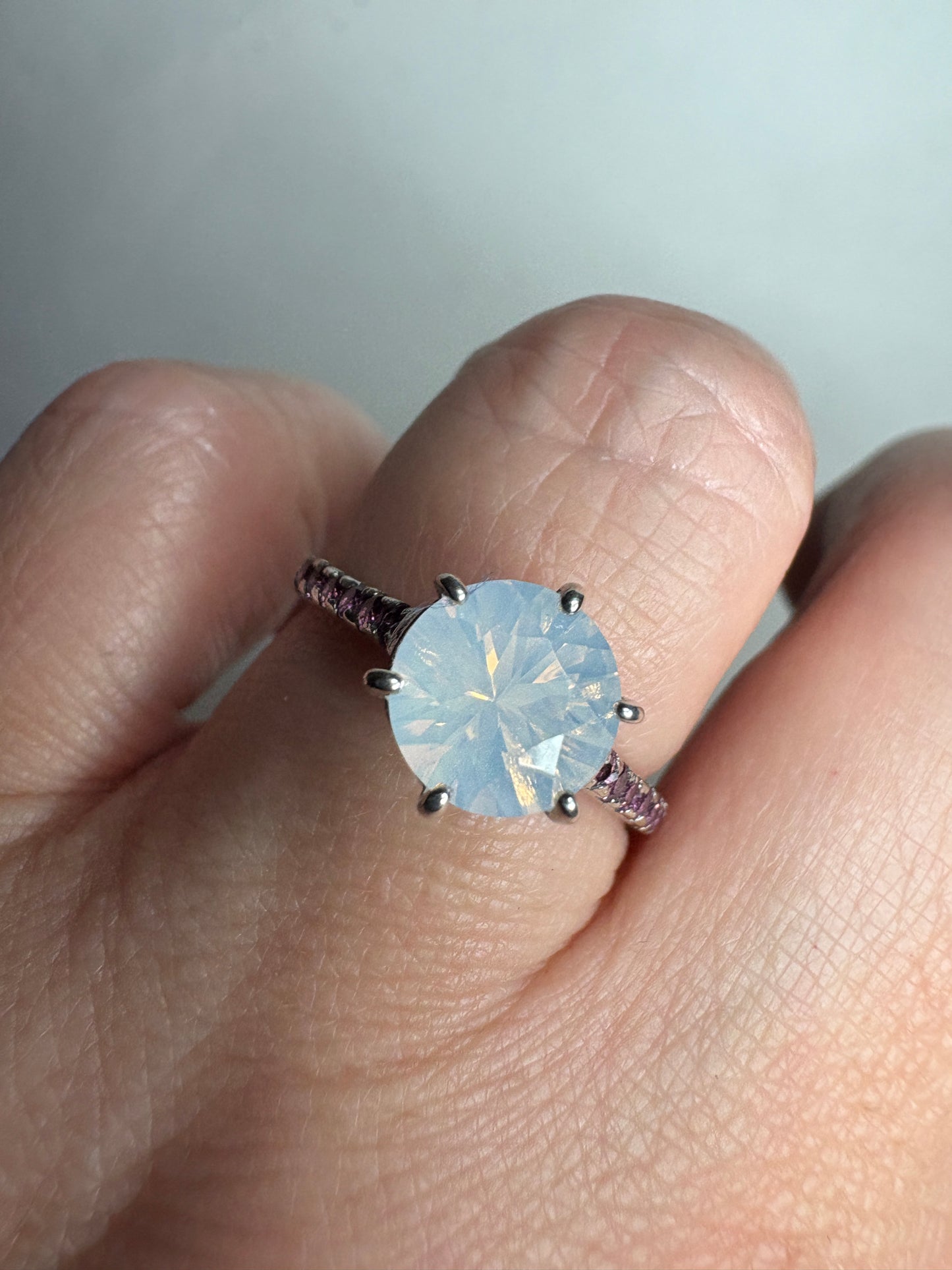 A sterling silver ring with a milky white quartz and rhodolite garnets.