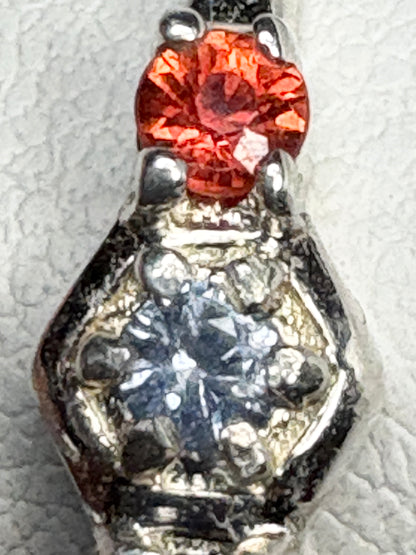 Sterling silver ring with a red gemstone and honeycomb pattern.